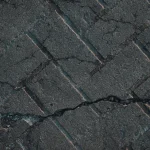 Cracked asphalt pavement close-up