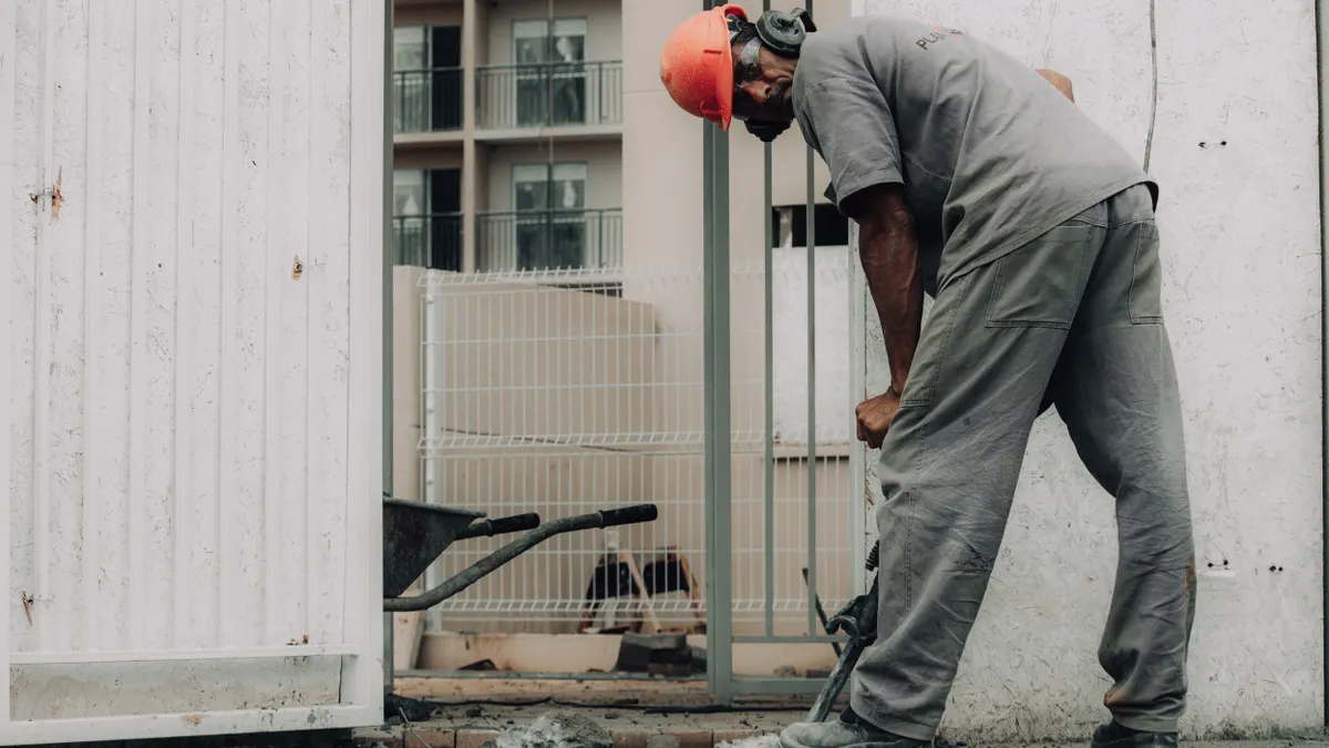 How to Fix Cracks at the Edge of a Concrete Slab Worker jackhammering a concrete edge